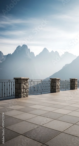 Stone terrace with iron railing overlooking majestic mountain peaks in the morning light