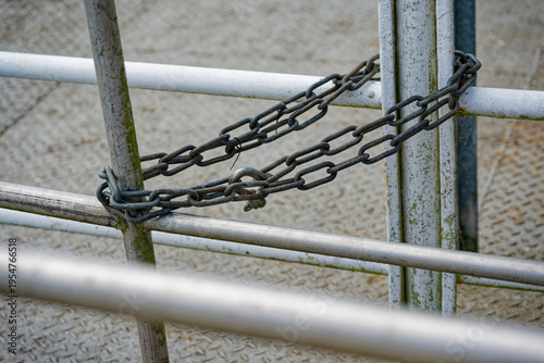 Bild auf Leinwand Two metal fences linked with double chain and padlock securing access