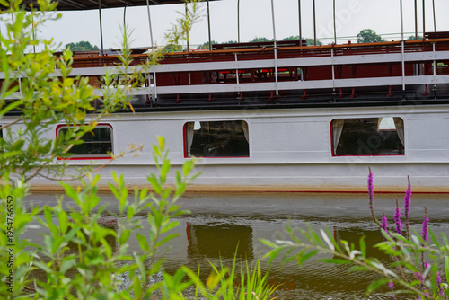 Bild auf Leinwand White passenger ferry with enclosed cabin and open upper deck seating
