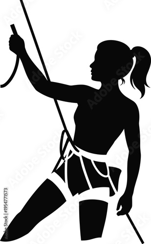 Silhouette of a female rock climber in a harness holding a climbing rope preparing for an indoor or outdoor ascent