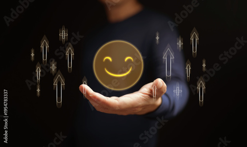 Foto Mental health, wellness, and well-being concept, A man holds a happy face icon surrounded by upward arrows