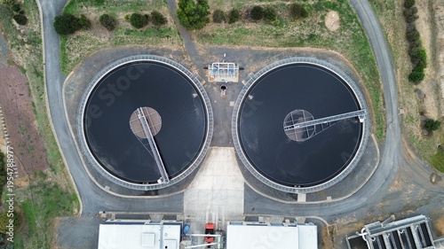 Photography Aerial top down view of circular wastewater treatment tanks at industrial water