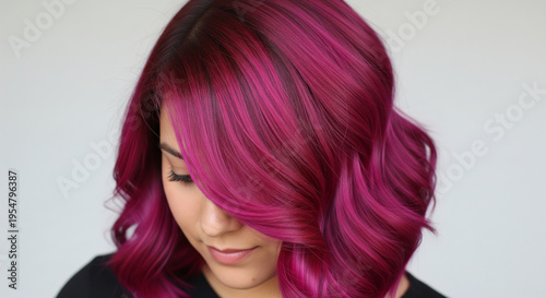 A striking rear view of a woman with beautiful hair dyed a vibrant magenta color.