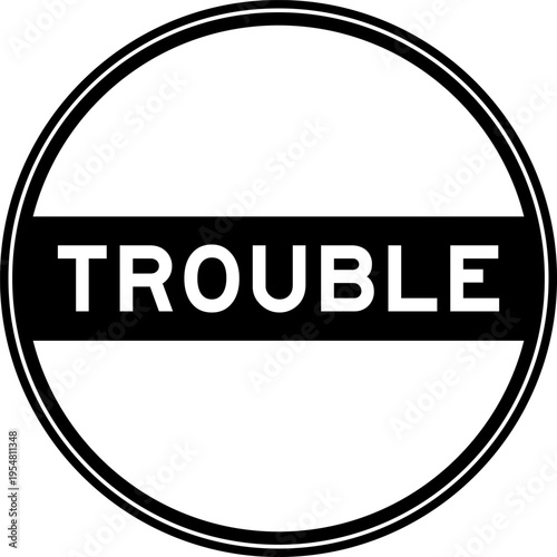 Black color round seal sticker in word trouble on white background