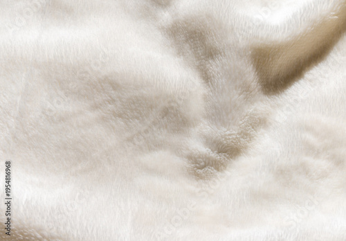Soft white faux fur texture background with wavy organic folds for winter fashion and cozy home textile design