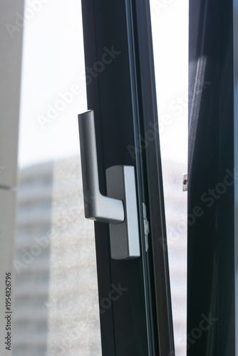 Open PVC window sash with slightly visible mosquito net, selective focus, shallow depth of field