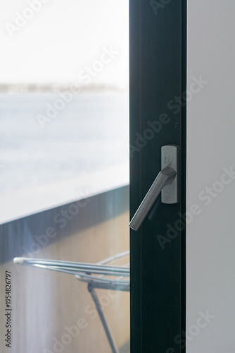 Metal-plastic balcony door. Metal-plastic door handle, selective focus, shallow depth of field.