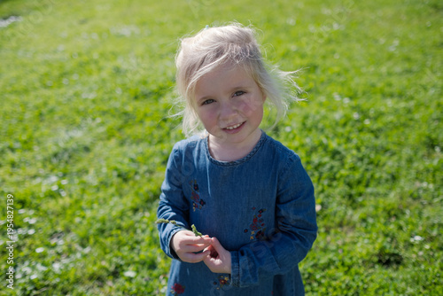 Close up portrait of a lovely 4 year old girl walking outdoors