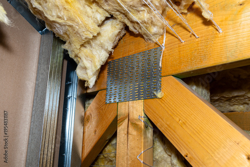 Foto Building insulation materials with wooden rafters and metal profiles
