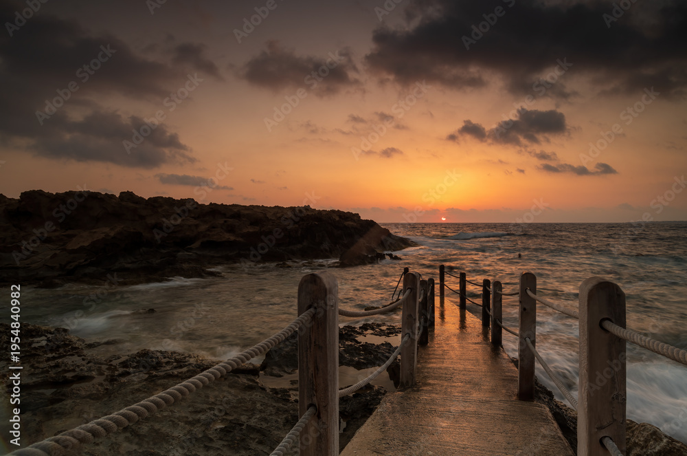 Fototapeta premium Sunset Over Cyprus Coastline with Golden Mediterranean Light