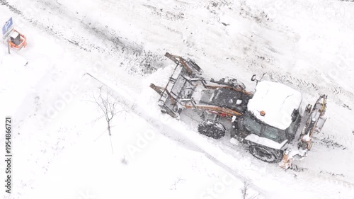 Snow removal machine clearing road in winter aerial view urban infrastructure and municipal service concept