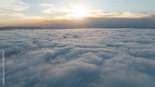 Принти на полотні Panoramic aerial view above white clouds sun shining clear sky