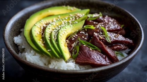 Delicious bowl of rice topped with succulent beef slices, fresh avocado, and vibrant green onions, sprinkled with sesame seeds for a gourmet touch