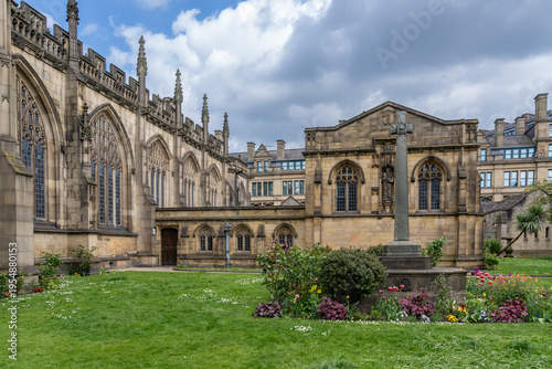 Manchester Cathedral Gardens with Blue Sky and White Clouds
