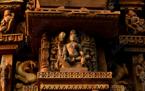 Stone carving bas relief sculptures on Khajuraho Temple, India.