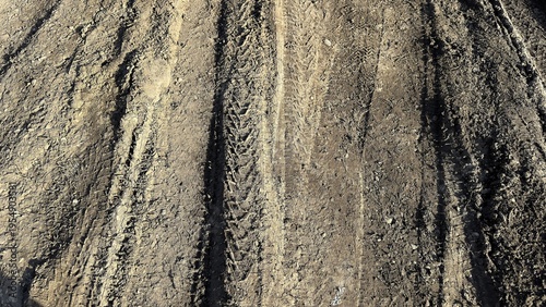 Принти на полотні Textured sandy soil with deep ruts showing heavy machinery grading at roadside,