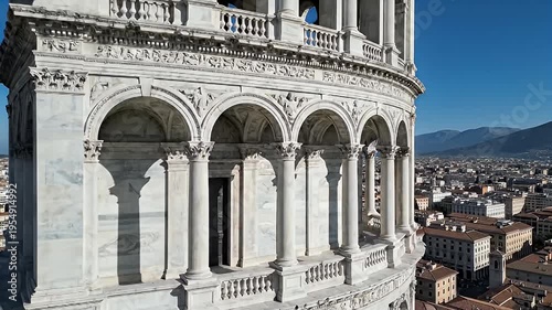 Elegant White Marble Loggia with Arches and Columns Overlooking a European Cityscape Under Clear