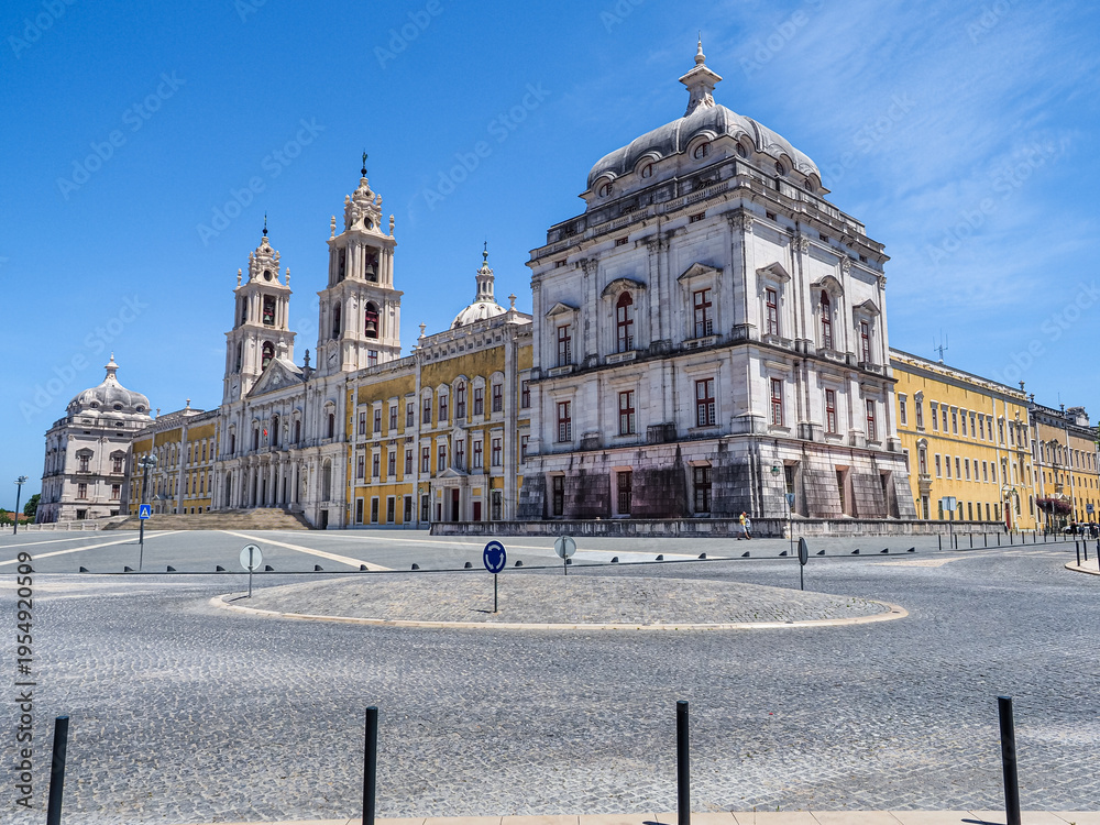 Obraz premium Famous Portuguese Royal Building, National Palace of Mafra or Palacio de Mafra. Monumental Baroque and Neoclassical Convent - Monastery, Basilica, with the tower carillons and Flemish bronze bells.