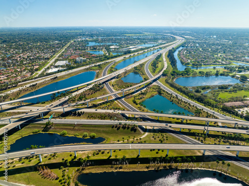 Fotografie Aerial view of American freeway intersection with fast driving cars and trucks in Miami, Florida