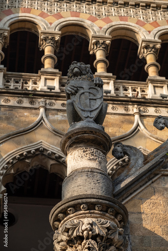 Detailed stone newel post at Chhatrapati Shivaji Maharaj Terminus (CST) showing carved lion with shield, ornate Gothic‑Revival carvings, close‑up