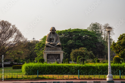 Obraz na plátně Statue of Mahatma Gandhi against road, a freedom fighter known for peace and the side view of Vikasa Soudha building
