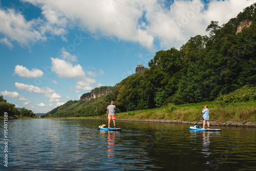 Photos Couple Paddleboarding on Elbe River in Germany During Summer SUP Tour Adventure