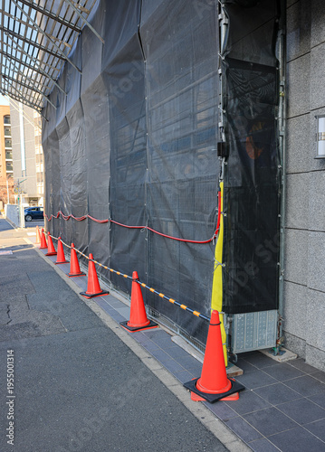 Covered facade of a reconstruction building, Scaffolding with safety nets during renovation building.