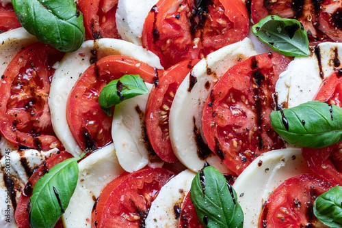 Tableau sur toile A close up look at a Caprese salad drizzled with balsamic glaze.