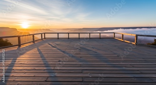 Wooden observation deck overlooking a misty canyon at sunrise
