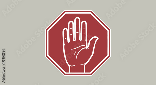A stop sign with a hand gesture is shown outdoors on a gray background.