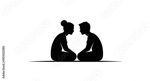 Silhouette of a couple meditating face to face in a serene setting.