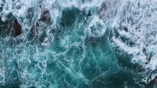 A mesmerizing drone shot taken from above, capturing the natural foam created as turquoise waves crash against the coastal rocks along Gazipaşa’s pristine shoreline.