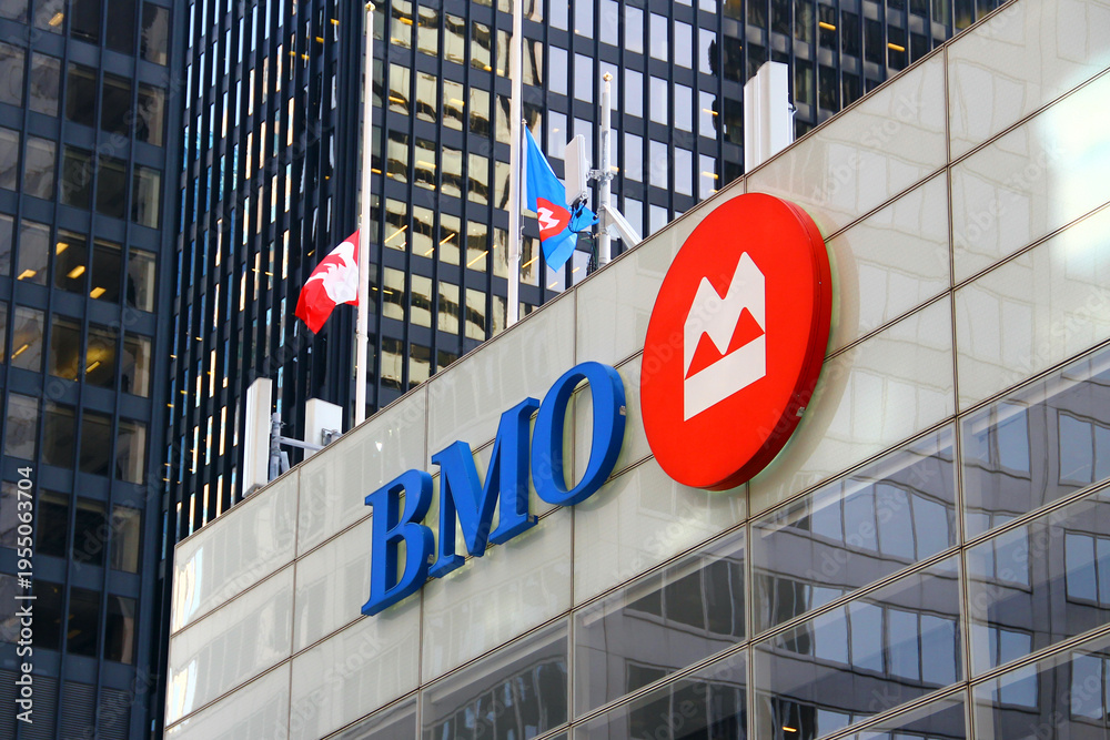 Fototapeta premium Toronto, Canada - February 15, 2026: Bank of Montreal headquarters building with corporate logo and flags in Toronto downtown financial district
