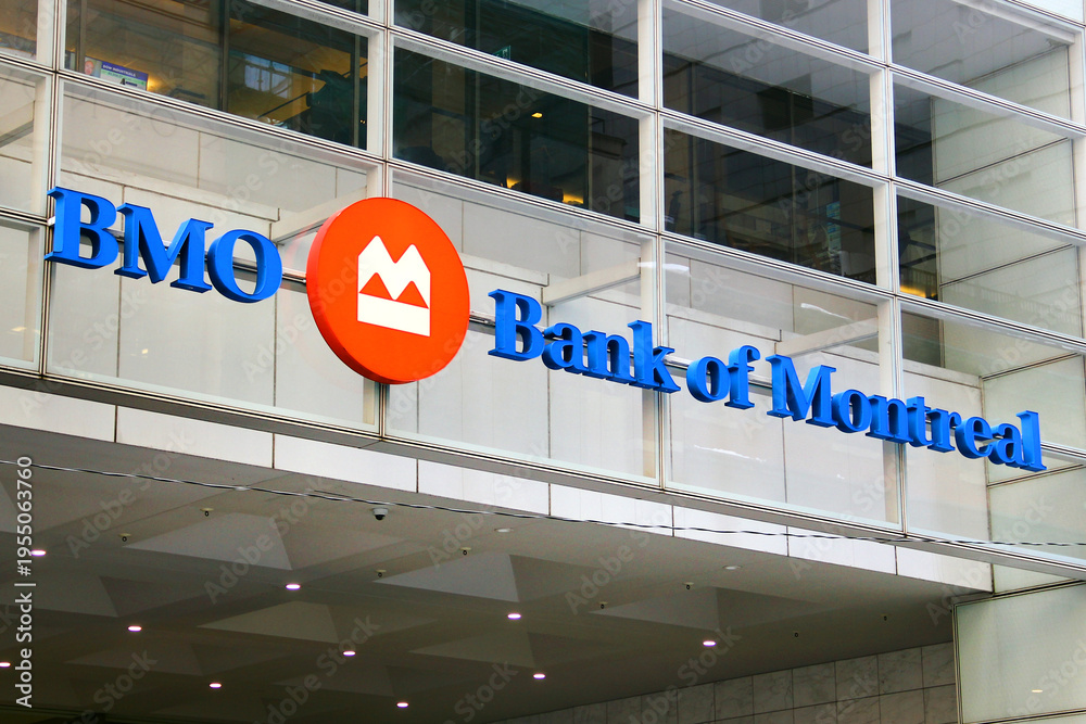 Fototapeta premium Toronto, Canada - February 15, 2026: Bank of Montreal headquarters building with corporate logo and flags in Toronto downtown financial district