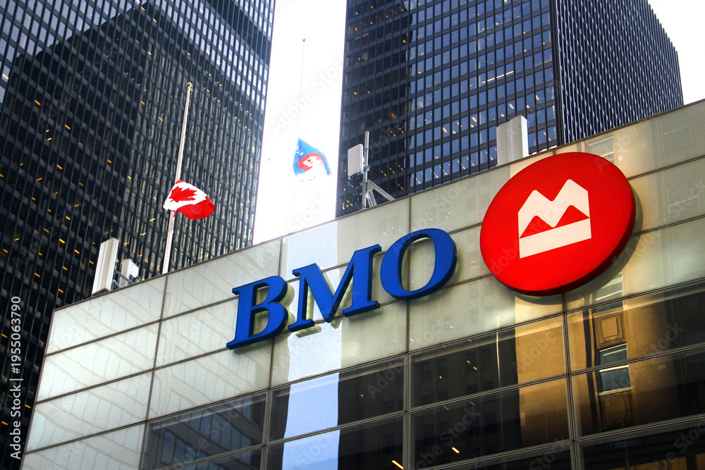 Fototapeta premium Toronto, Canada - February 15, 2026: Bank of Montreal headquarters building with corporate logo and flags in Toronto downtown financial district