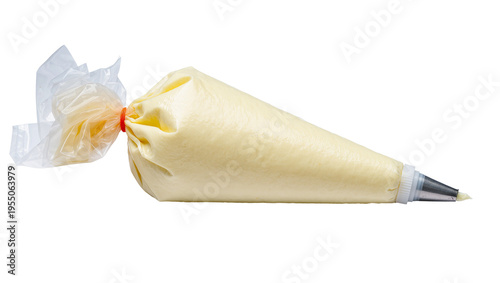 Bild auf Leinwand Isolated pastry piping bag with creamy yellow frosting and metal nozzle for cake