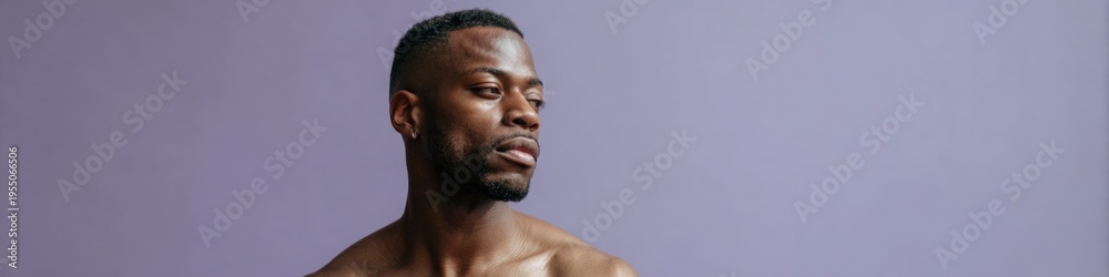 Fototapeta premium African male adult torso strong athletic barechest against soft purple backdrop dramatic side gaze conveying strength and poise for fitness concepts