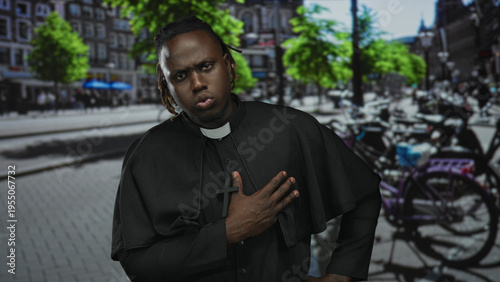 Man priest with hand on chest holding wooden cross, wearing clerical collar on busy city street with bicycles and trees; devotion prayer.