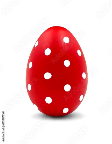 Photo of a handcrafted red Easter egg, decorated with charming white polka dots, isolated on white background.