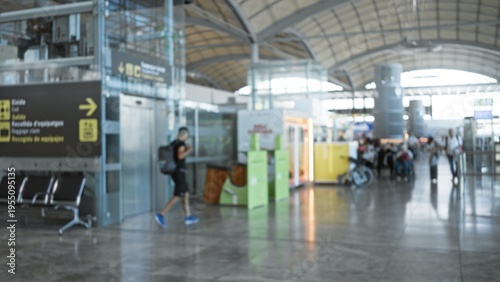 Wallpaper Mural Airport terminal blurred bokeh background interior showing soft defocused concourse, signage and glossy marble floor reflections; backdrop copyspace backplate calm. Torontodigital.ca