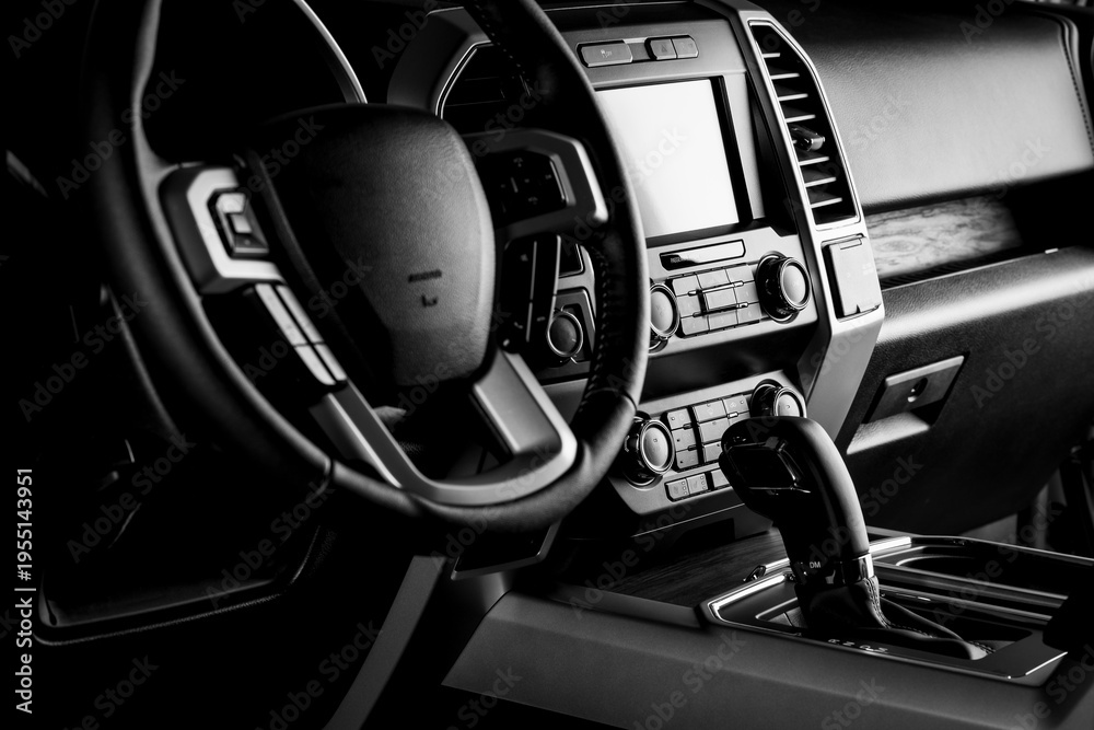 Obraz premium Car interior dashboard with modern details, multimedia screen system, gear lever and luxury concept - black and white