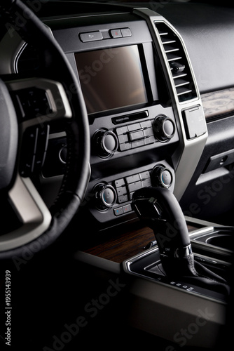 New car cockpit with multimedia screen, air conditioning, steering wheel with electric buttons and automatic gear lever - comfortable for the driver