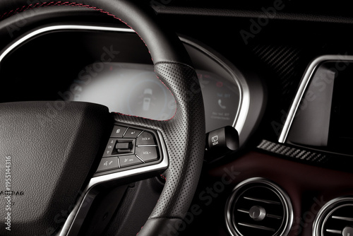 Close-up steering wheel inside a new suv car with digital speedometer display