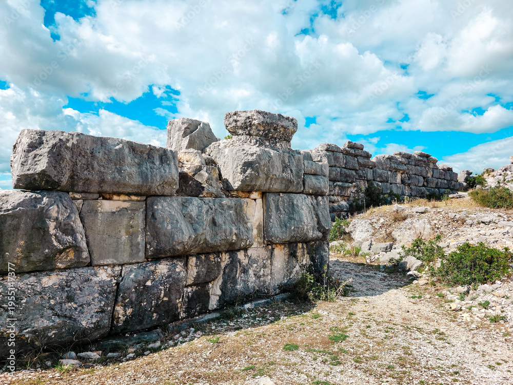 Fototapeta premium Close-up of massive megalithic stone wall in ancient Illyrian city of Daorson, Bosnia and Herzegovina. Detailed texture of historic ruins, archaeological background and ancient construction.