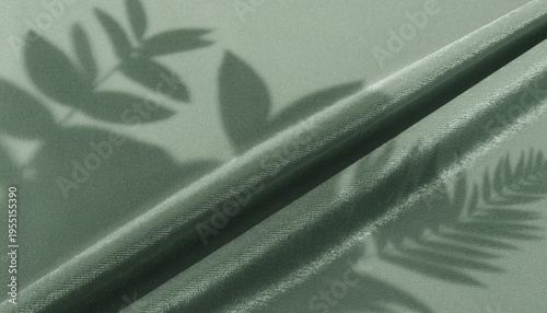 Soft shadows of botanical leaves on a textured surface create a serene, minimalist backdrop