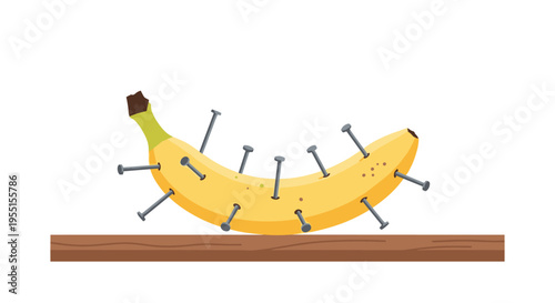 Creative concept of banana with nails on wooden surface for