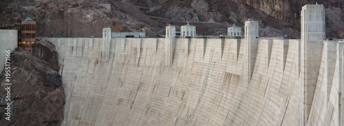 Panoramic view of Hoover Dam’s upper downstream face with the crest, intake tower tops, and the visitor center on the left.