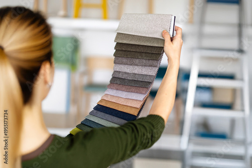 Bilde på lerret Interior design consultant choosing fabric swatch collection in showroom for hom