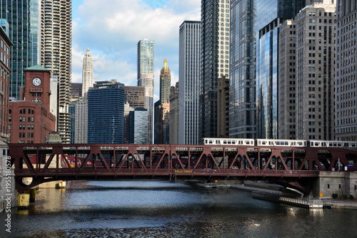 A train crosses the Chicago River with the skyline in the background in downtown Chicago.