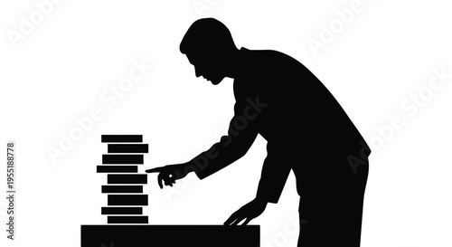 Black silhouette of a man stacking books on a table, symbolizing education, learning, and business growth